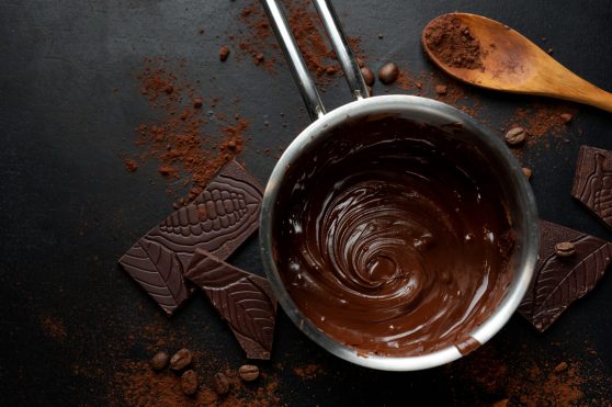 Melting chocolate in pot on dark